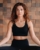 A young woman in black clothes is doing yoga in a modern gym.The concept of health.